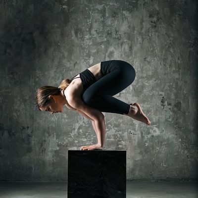 Side view of a person engaging their core muscles in a controlled pose.